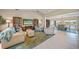 Spacious living room with comfortable seating, shelving, and a view to dining room at 413 Valletta Ct, Punta Gorda, FL 33950