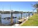 Water view with boat lift highlighting waterfront living and boating access with well-maintained seawall and grassy area at 413 Valletta Ct, Punta Gorda, FL 33950