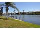 Scenic waterfront featuring lush green grass and a neighborhood with multiple boat docks at 413 Valletta Ct, Punta Gorda, FL 33950
