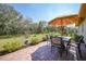 Outdoor patio with table and chairs, perfect for dining al fresco in the well-maintained backyard at 468 Paramaribo St, Punta Gorda, FL 33983