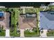 An aerial view reveals the home's tile roof, backyard, and landscaping at 5032 La Costa Island Ct, Punta Gorda, FL 33950