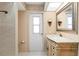Bathroom boasts a tile shower and a vanity with elegant vanity mirror at 5032 La Costa Island Ct, Punta Gorda, FL 33950