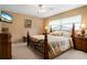 Comfortable bedroom featuring a wrought iron bed frame and neutral color scheme at 5032 La Costa Island Ct, Punta Gorda, FL 33950