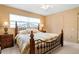 Comfortable bedroom featuring a wrought iron bed frame and neutral color scheme at 5032 La Costa Island Ct, Punta Gorda, FL 33950