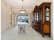 Elegant dining room with decorative hutch, glass table, and sliding door to patio at 5032 La Costa Island Ct, Punta Gorda, FL 33950