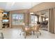 Bright dining area with a glass table, wicker chairs, tile flooring, and lake views at 5032 La Costa Island Ct, Punta Gorda, FL 33950