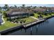 Waterfront home featuring a screened lanai, landscaped yard, and private dock at 5032 La Costa Island Ct, Punta Gorda, FL 33950