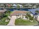 Charming single-story home featuring a well-manicured lawn, brick driveway, and attached garage at 5032 La Costa Island Ct, Punta Gorda, FL 33950