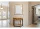 Foyer with decorative front doors, tiled floor, hall table, and access to laundry at 5032 La Costa Island Ct, Punta Gorda, FL 33950