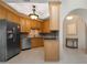 Open kitchen features wood cabinetry, stainless steel appliances, granite countertops, and tile flooring at 5032 La Costa Island Ct, Punta Gorda, FL 33950