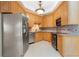 Modern kitchen featuring stainless steel appliances, granite countertops, and ample cabinet space at 5032 La Costa Island Ct, Punta Gorda, FL 33950