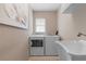 Well-lit laundry room equipped with modern appliances and a utility sink at 5032 La Costa Island Ct, Punta Gorda, FL 33950