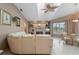 Cozy living room boasting a stone fireplace, neutral decor, lots of light, and tile flooring at 5032 La Costa Island Ct, Punta Gorda, FL 33950