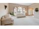 Bright living room with white sofa, large window, and elegant decor at 5032 La Costa Island Ct, Punta Gorda, FL 33950
