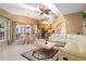 An airy layout featuring the living room, kitchen, and dining area with access to the patio at 5032 La Costa Island Ct, Punta Gorda, FL 33950