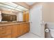 Main bathroom includes a vanity, large mirror, and toilet with storage at 5032 La Costa Island Ct, Punta Gorda, FL 33950