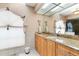 Main bathroom includes a vanity area and tiled shower at 5032 La Costa Island Ct, Punta Gorda, FL 33950