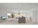 Bright and open main bedroom with sitting area, sliders to the patio, ceiling fan, and skylight at 5032 La Costa Island Ct, Punta Gorda, FL 33950
