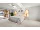 Airy main bedroom with a fan, light walls, tile floor, and private access to the patio at 5032 La Costa Island Ct, Punta Gorda, FL 33950