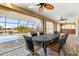 Relaxing outdoor patio with ceiling fans, wrought iron table set, and views of the pool and canal at 5032 La Costa Island Ct, Punta Gorda, FL 33950
