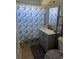 Bathroom features gray vanity, shower with seashell curtain, and tiled floors at 5100 Bullard St, North Port, FL 34287