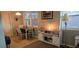 Bright dining area features tile floor, white table and chairs, and updated media center at 5100 Bullard St, North Port, FL 34287