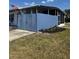Quaint home with a charming blue fence, green lawn, and an inviting front exterior at 5100 Bullard St, North Port, FL 34287