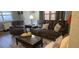 Cozy living room with comfortable reclining sofa and chair, complemented by natural light and a classic coffee table at 5100 Bullard St, North Port, FL 34287