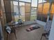 Enclosed sunroom with tile floor and casual seating, providing a tranquil space at 5100 Bullard St, North Port, FL 34287