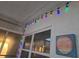 Enclosed patio featuring string lights, windows, and a decorative vintage sign at 5100 Bullard St, North Port, FL 34287