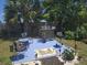 Inviting backyard patio featuring comfortable seating, a bar area, and a grill at 5100 Bullard St, North Port, FL 34287