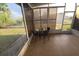 Screened porch featuring a table with chairs and a view of the backyard at 5100 Bullard St, North Port, FL 34287