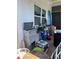 Cluttered screen porch with tools and equipment with a window to the backyard at 5100 Bullard St, North Port, FL 34287
