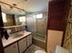 Vintage bathroom with a unique shower design, vanity, and storage at 6830 Pleasant Ct, North Port, FL 34287