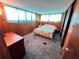 Comfortable bedroom with a dresser, closet space, and soft natural lighting at 6830 Pleasant Ct, North Port, FL 34287