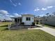 Charming single-story home with carport, screen door, and well-maintained lawn under a sunny sky at 6830 Pleasant Ct, North Port, FL 34287