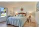 Comfortable bedroom with a plush bed, decorative wall art, and a relaxing ambiance at 821 Bayard St, Port Charlotte, FL 33948