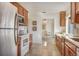 Modern kitchen with wooden cabinets, stainless steel appliances, and a view to the dining area at 821 Bayard St, Port Charlotte, FL 33948