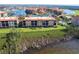 Stunning aerial view of the condo complex, showcasing its beautiful landscaping and proximity to a scenic lake at 93 Vivante Blvd # 9323, Punta Gorda, FL 33950