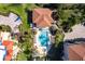 Aerial shot showcases the resort pool, lush tropical landscaping, patio seating, and a nearby hot tub at 93 Vivante Blvd # 9323, Punta Gorda, FL 33950