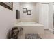 Bathroom featuring a large tub, tiled surround, and neutral decor at 93 Vivante Blvd # 9323, Punta Gorda, FL 33950