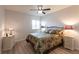 Comfortable bedroom featuring a ceiling fan, side tables with lamps, and a window for natural light at 93 Vivante Blvd # 9323, Punta Gorda, FL 33950