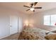 Bright bedroom featuring a ceiling fan, side table with a lamp, and a window providing plenty of natural light at 93 Vivante Blvd # 9323, Punta Gorda, FL 33950