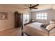 Bright bedroom featuring a ceiling fan, balcony access, and an armoire for ample storage at 93 Vivante Blvd # 9323, Punta Gorda, FL 33950