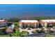 Beautiful condo building featuring a pool and lush landscaping with water views at 93 Vivante Blvd # 9323, Punta Gorda, FL 33950