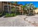 Exterior building with tropical landscaping and paved entrance at 93 Vivante Blvd # 9323, Punta Gorda, FL 33950