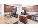 Bright kitchen with granite counters, stainless appliances and cherry wood cabinets and island at 93 Vivante Blvd # 9323, Punta Gorda, FL 33950