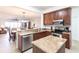 Modern kitchen with stainless appliances, granite counters, island and view of dining and living areas at 93 Vivante Blvd # 9323, Punta Gorda, FL 33950