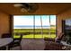 Serene lanai offering breathtaking views of the water, complemented by comfortable seating and a ceiling fan at 93 Vivante Blvd # 9323, Punta Gorda, FL 33950