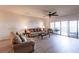 Spacious living room with updated flooring, ceiling fan, and sliding glass doors to deck at 93 Vivante Blvd # 9323, Punta Gorda, FL 33950